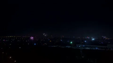 The view from a high point in the city to the many fireworks Stock Footage 146450202