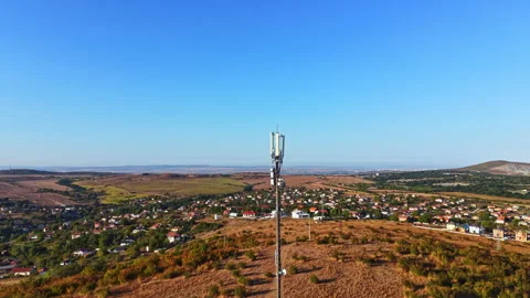 View from a high point shows a cell tower and small houses in a rural area 스톡 동영상 344778218