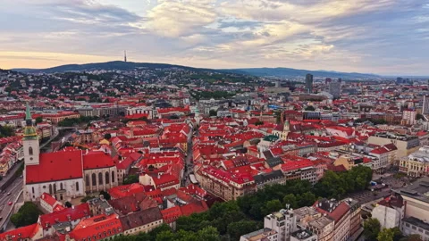 View from a high point shows cityscape with buildings and red roofs under cloudy Stock Footage 341702477