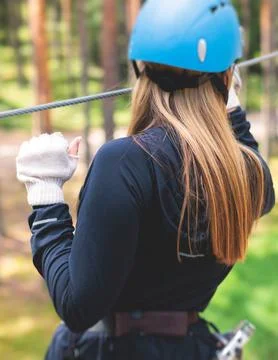 View of high ropes course, process of climbing in amusement acitivity rope pa 库存照片