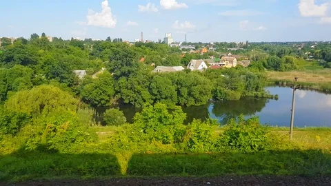 The view from the high-speed train on the beautiful scenery with hills, lake and Stock Footage 111398409
