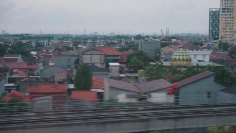 View from High Speed Train Window Passing Urban and Rural Landscape in Indonesia Stock Footage 332034642