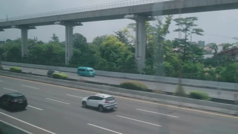 View from High Speed Train Window Passing Urban and Rural Landscape in Indonesia Stock Footage 332055835
