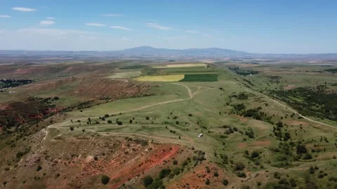 View of high steppe plateau with dirt roads and red soil cliffs in Kazakhstan Stock Footage 338117761