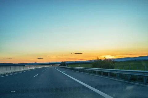 View of the highway from car during sunset. Stock Photos
