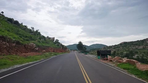 View of highway passing through scenic hills and natural landscape under op.. Stock Footage 339650277
