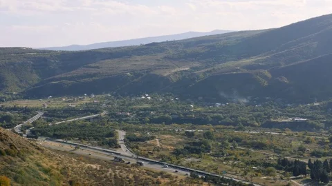 View of the highway road at the mountain area near river Stock Footage 82640560