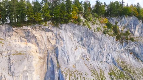 View of a hiking trail with a drone flying to a clif revealing a mountain behind Stock Footage 253113981