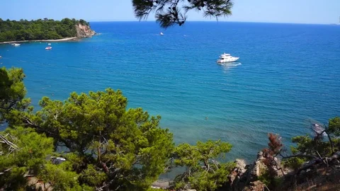 View from hill to Mediterranean Sea in Phaselis with yacht. City of ancient Stock Footage 107981071