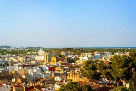 View from the hill to the old town surrounded by fields and mountains Stock Photos