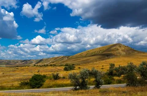 View of a hill with trees in the Eastern Crimea in the evening light 写真素材