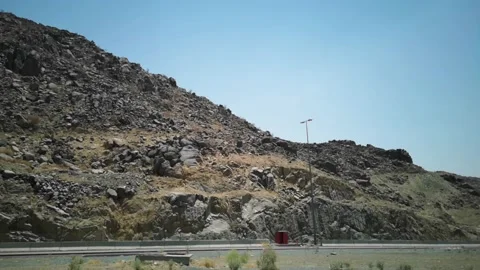 The view of the hills on the road with the background of the blue sky Stock Footage 130228195
