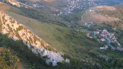 View of a Hillside With Homes in a Valley During the Evening Light in a Stock Footage 322934203