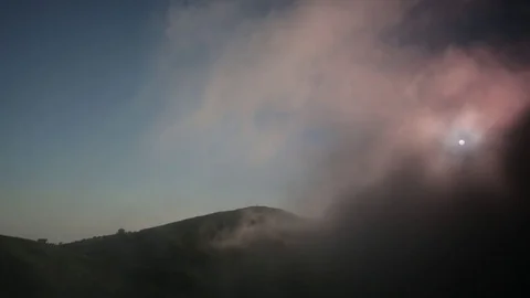 View of hilly terrain, almost hidden pink mist 스톡 동영상 85427983
