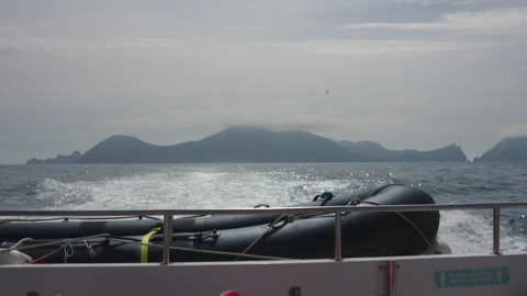 View of Hirta (St Kilda) from the back of a moving tourist boat Stock Footage 229743180
