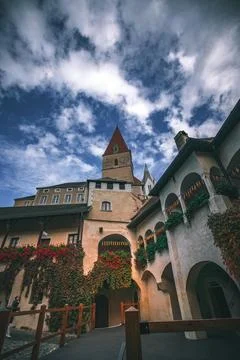 A view of a historic building with a clock tower in Joching, Austria. The Stock Photos