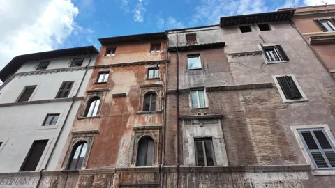 View of the historic facade and windows of a traditional Roman building in Italy Stock Footage 338010394