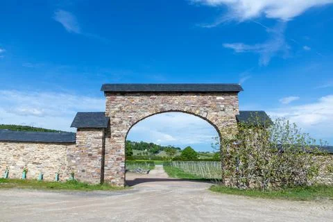 View to historic gate in arch style leading to the vineyards of cloister Eb.. Stock Photos