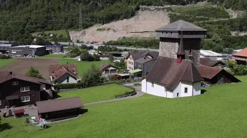 View of a historic stone tower and village in Lugano, Switzerland. 스톡 동영상 343670775