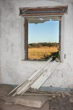 View from the hole of an old window without hinges on the pasture of Extremad Stock Photos