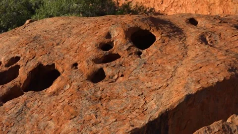 View of holes on surface of Uluru monolith, Australia Stock Footage 278097656