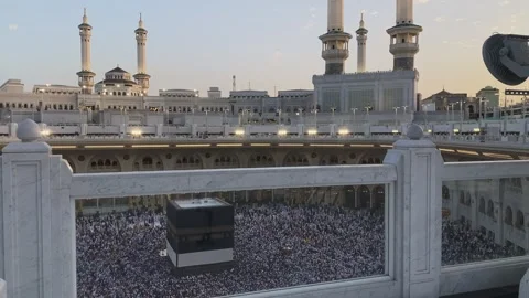 View of Holy Kaaba and massive crowd through marble railing at Masjid al-Haram Stock Footage 340195024