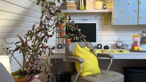 A view of a home office workspace in a bedroom with grey tones and yellow accent Vídeos de archivo 308235158
