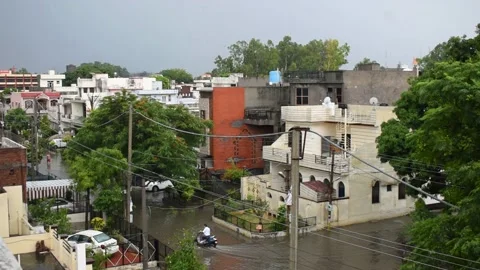 View of homes and road in rainy day of monsoon in Khanna, Punjab Indian Stock Footage 155179918