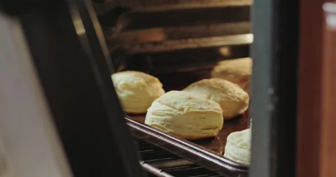 View into a hot oven of breakfast biscuits cooking Stock Footage 293338978