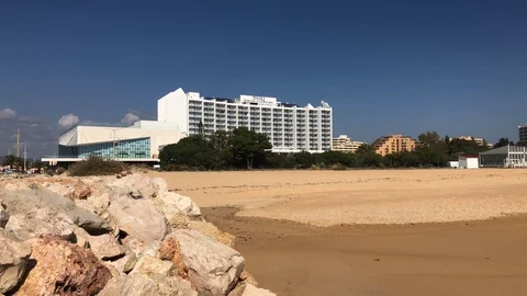 View of hotel and beach front on the coast Portugal Vilamoura Stock Footage 98413828