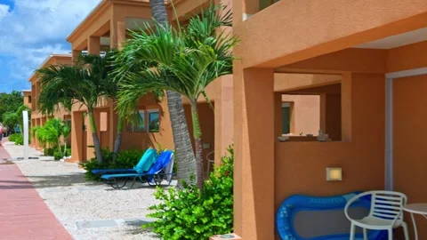 View of a hotel with a patio located on its own sandy beach on the island Stock Footage 278187437