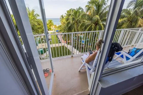 View of hotel room interior with open balcony overlooking Atlantic Ocean, Stock Photos