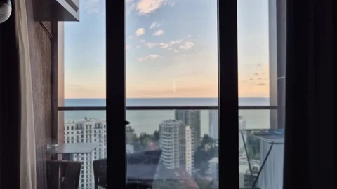View from the hotel window overlooking the sea in the evening at sunset Stock Footage 306617487