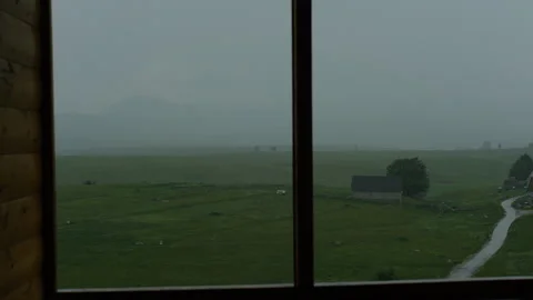 View from house  window on hill with rain drops in storm weather Stock Footage 138739624