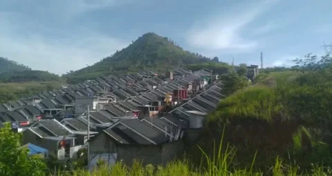 A view of a housing complex at the foot of a small hill Stock Footage 219781951