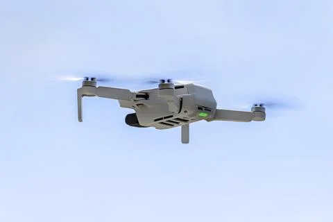 View of the hovering drone from rear against a blue sky background, the plast Stock Photos