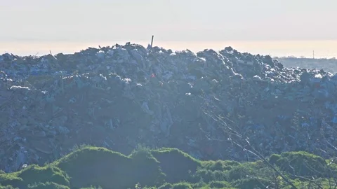 View on huge junk yard and walking trucks with city on the background Stock Footage 75266841