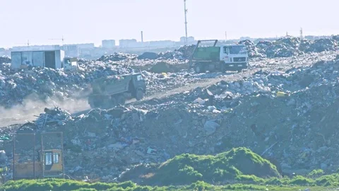 View on huge junk yard and walking trucks with city on the background Video stock 75266856