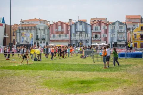 View huge park with people practicing zumba, background with colorful striped Stock Photos
