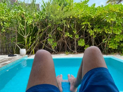 View of human feet by the pool Stock Photos