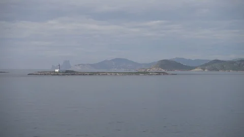 View to an ibiza lighthouse sailing from the boat Stock Footage 99699174