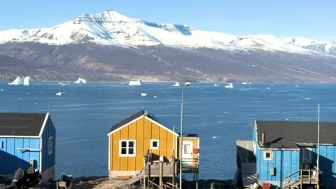 View of icebergs and mountains in the distance at a coastal village in Greenland Stock Footage 339999751