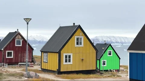 View of icebergs and mountains in the distance at a coastal village in Greenland Stock Footage 339999756