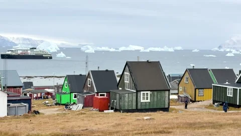 View of icebergs and mountains in the distance at a coastal village in Greenland Stock Footage 339999757