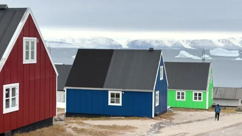 View of icebergs and mountains in the distance at a coastal village in Greenland Stock Footage 339999758