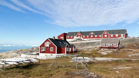 View of icebergs and mountains in the distance at a coastal village in Greenland Stock Footage 339999788