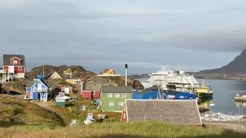 View of icebergs and mountains in the distance at a coastal village in Greenland Stock Footage 339999790