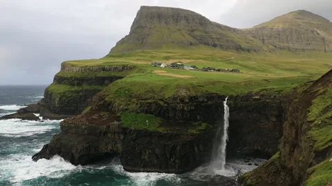 View of iconic Múlafossur waterfall and Gasadalur in the Faroe Islands. 動画素材 154552046
