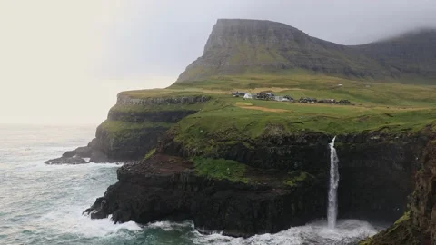View of iconic Múlafossur waterfall and Gasadalur in the Faroe Islands. Stock Footage 154552291