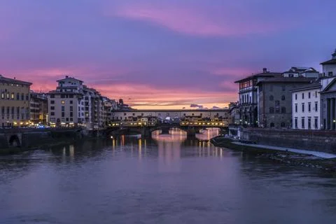 View of the iconic Ponte Vecchio over the Arno River at dusk in Florence, I.. Stock Photos